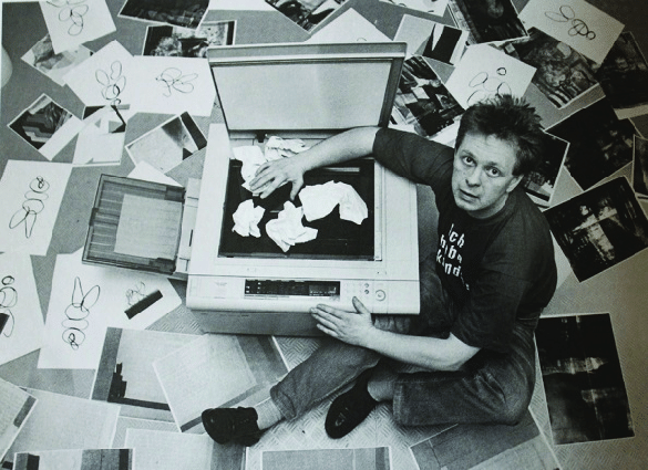 Black and white image of Jürgen, top down, papers on a scanner