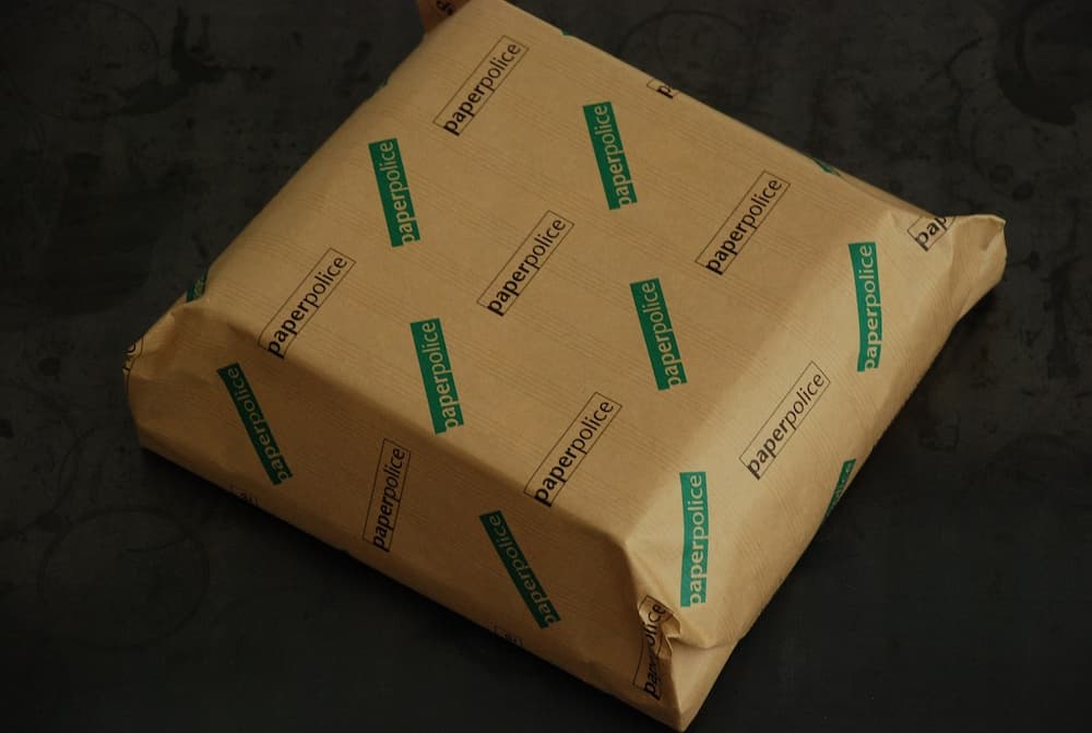 Image of box wrapped with 'Paper Police' paper